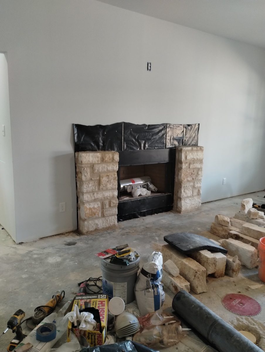 Stone masonry in Hamilton County, Texas — limestone fireplace surround under construction by WhiteStone Construction
